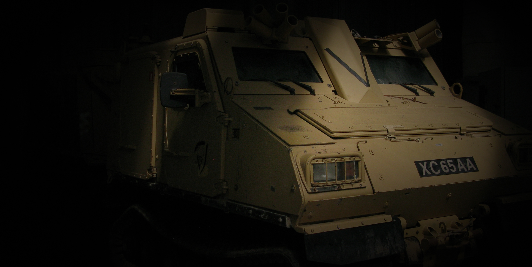 Armored vehicle in a darkened hangar